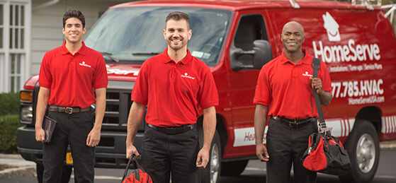 Three HomeServe repairmen outside truck.