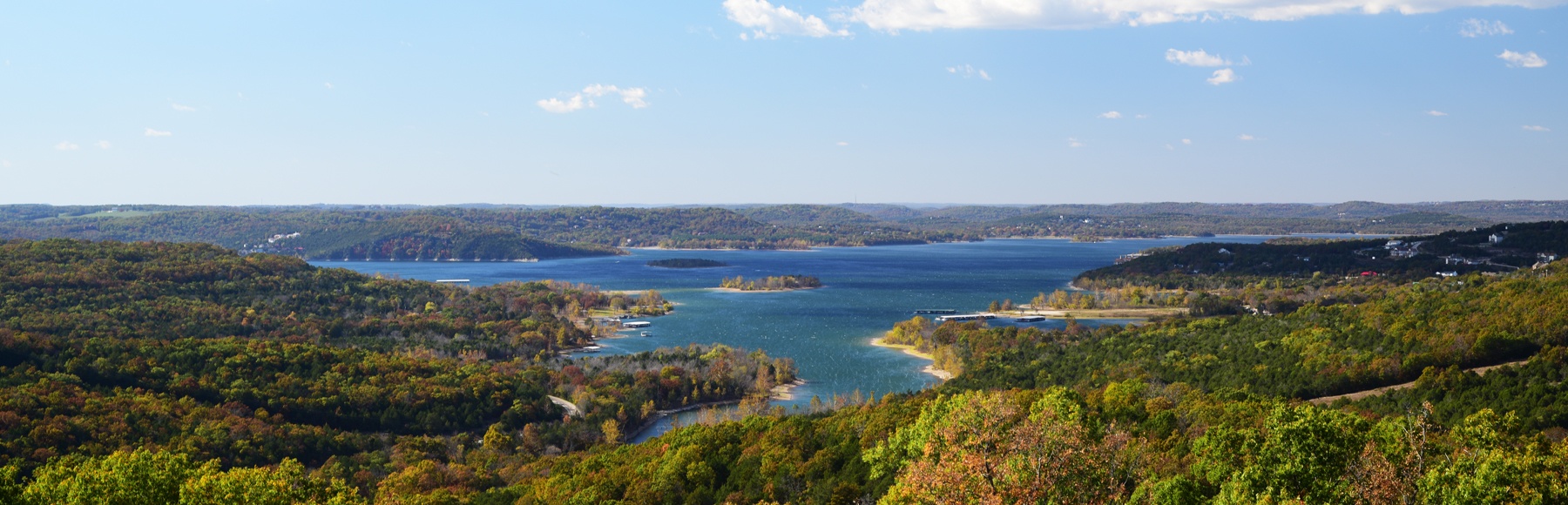 Landscape scene of a lake surrounded by foilage